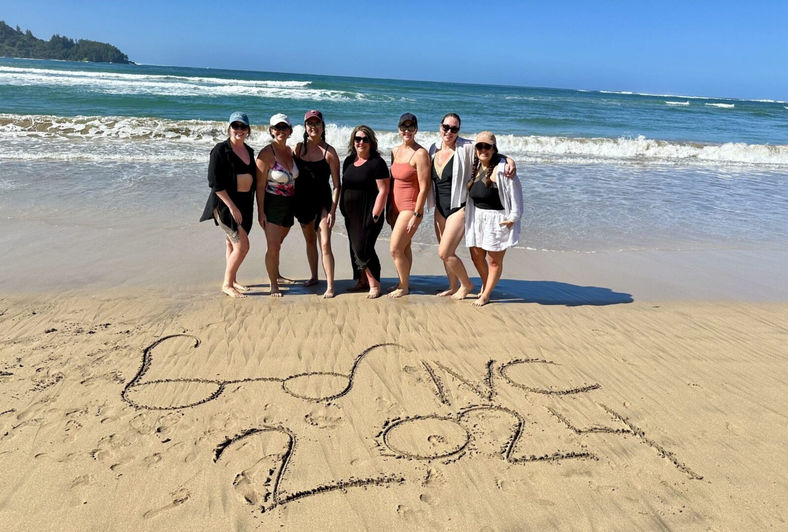 Group of women on beach, "BVIYC 2024" written.