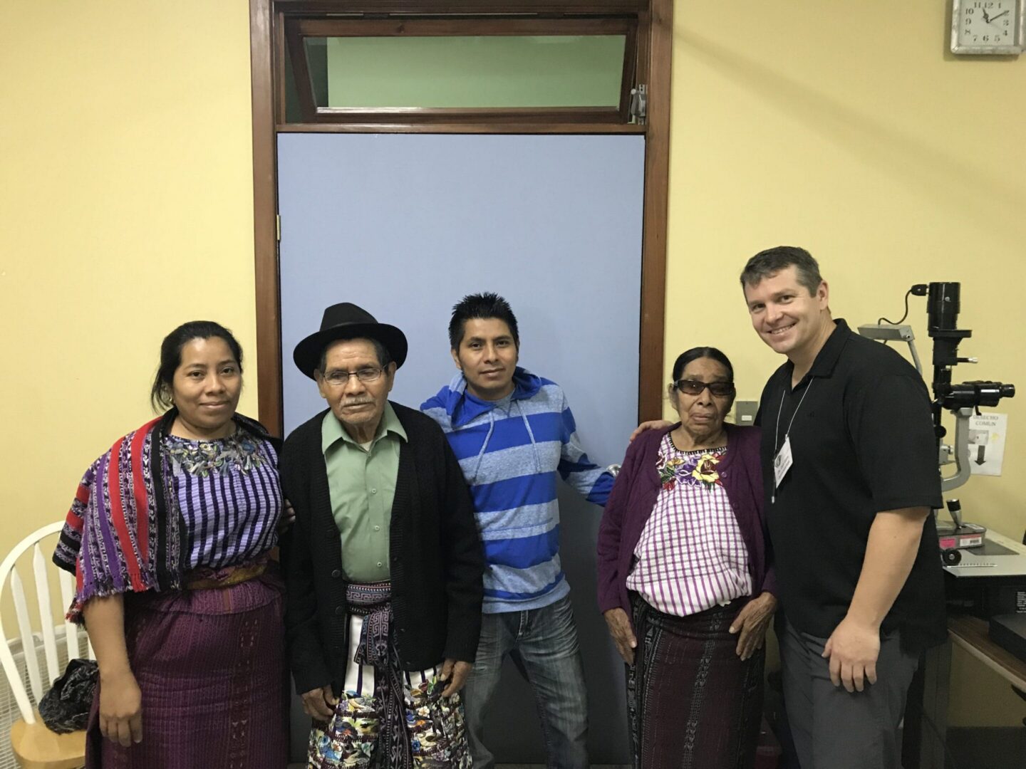 Group of people in traditional clothing indoors.