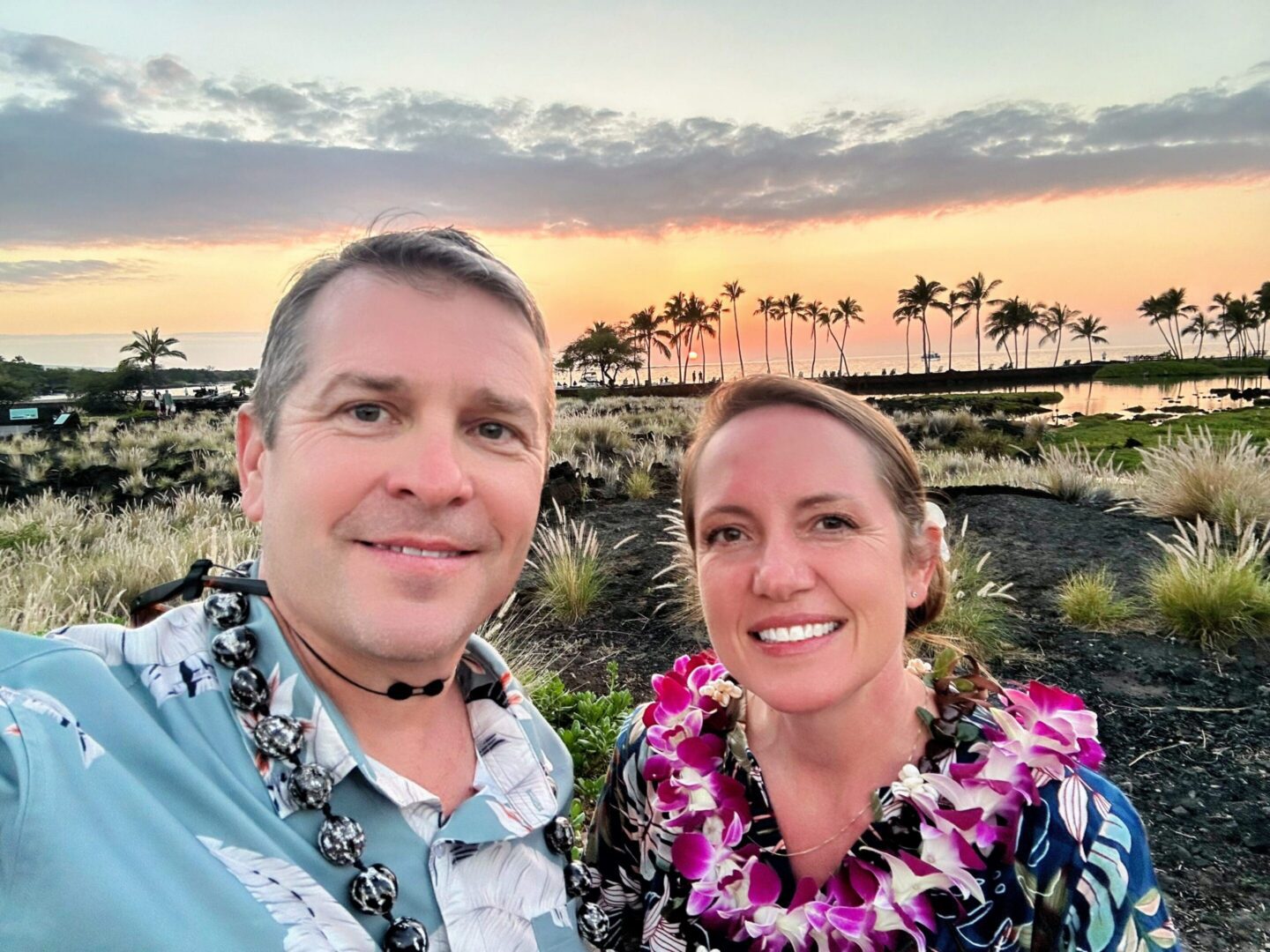 Sunset beach selfie with floral leis