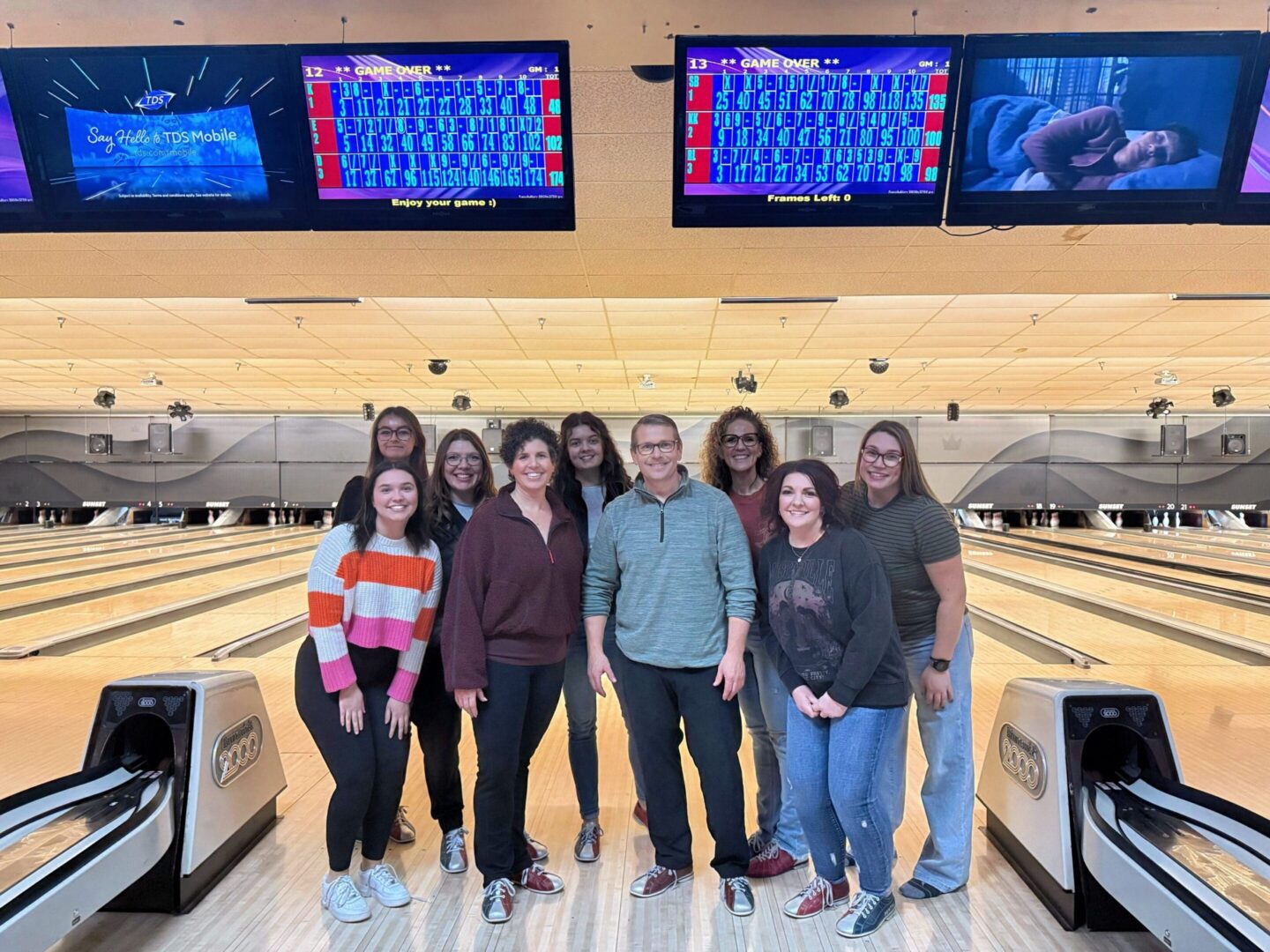Group of people posing at a bowling alley