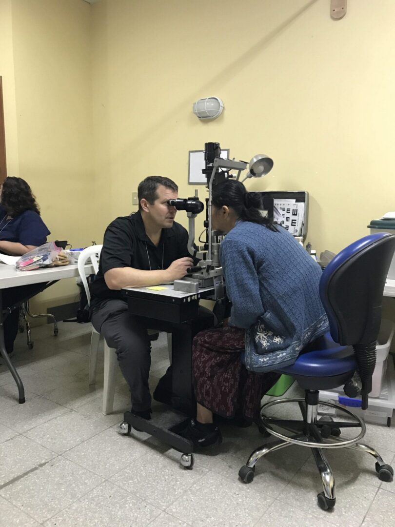 Optometrist conducting a vision assessment for patient.