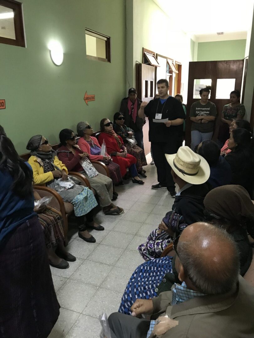 People gathered in a hallway meeting