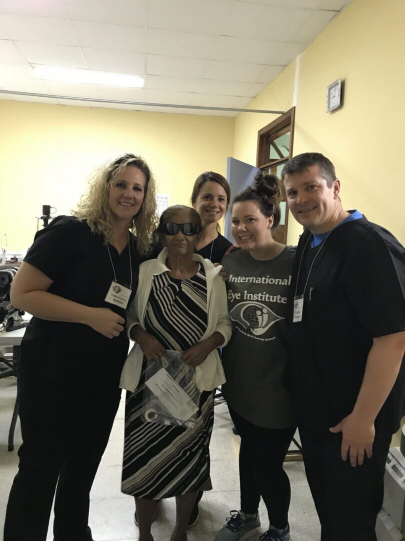 Smiling team with elderly woman