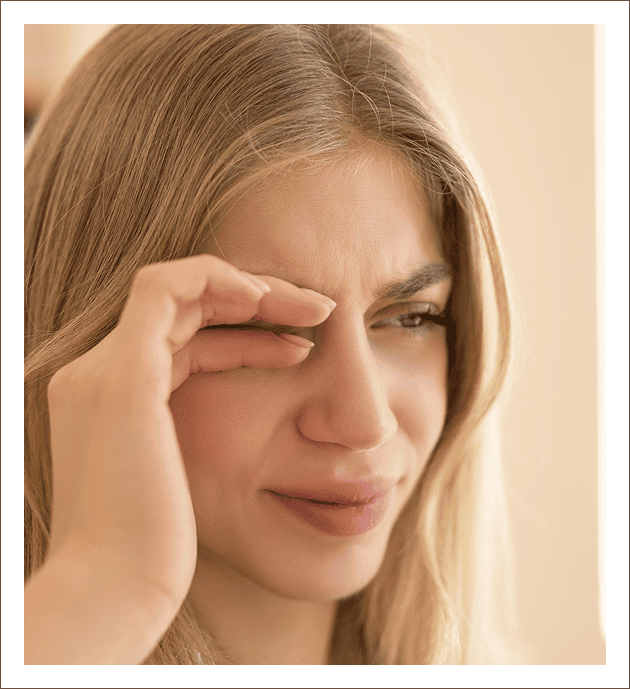 Person with hands on face showing strain