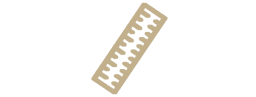 Beige plastic ruler with a white background and a number of holes in it, resembling a slide rule